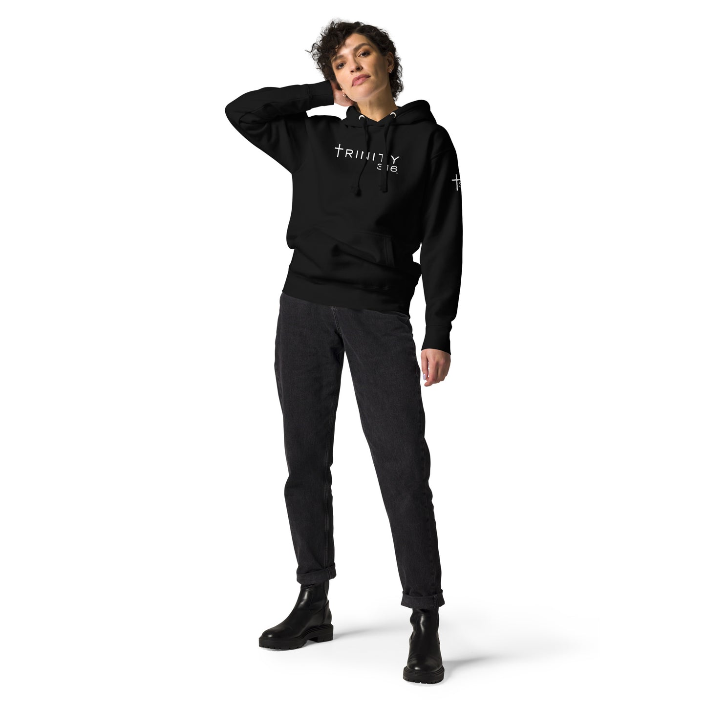 A woman dressed in a black hoodie and black pants, showcasing a stylish unisex-premium-hoodie-black-front look.
