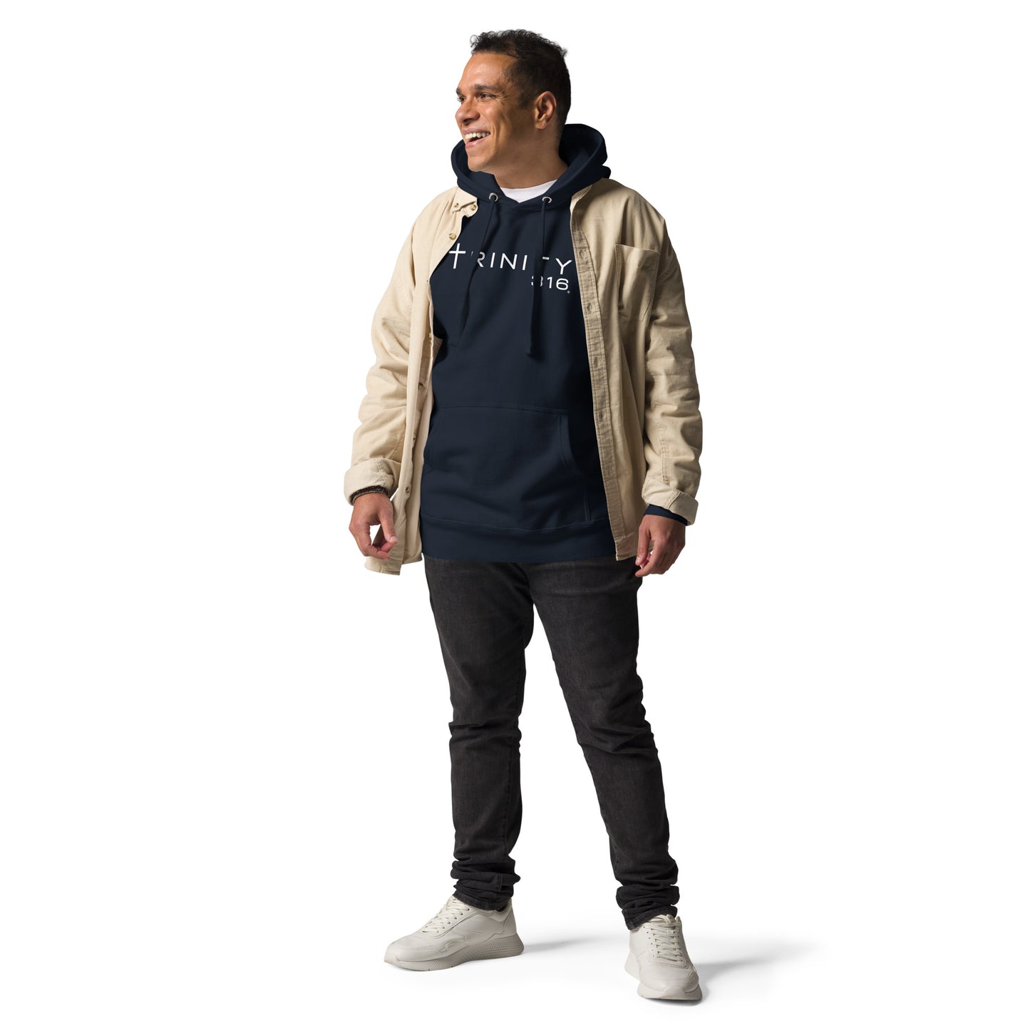 A man in a navy blazer unisex premium hoodie and jeans poses confidently for a photo.