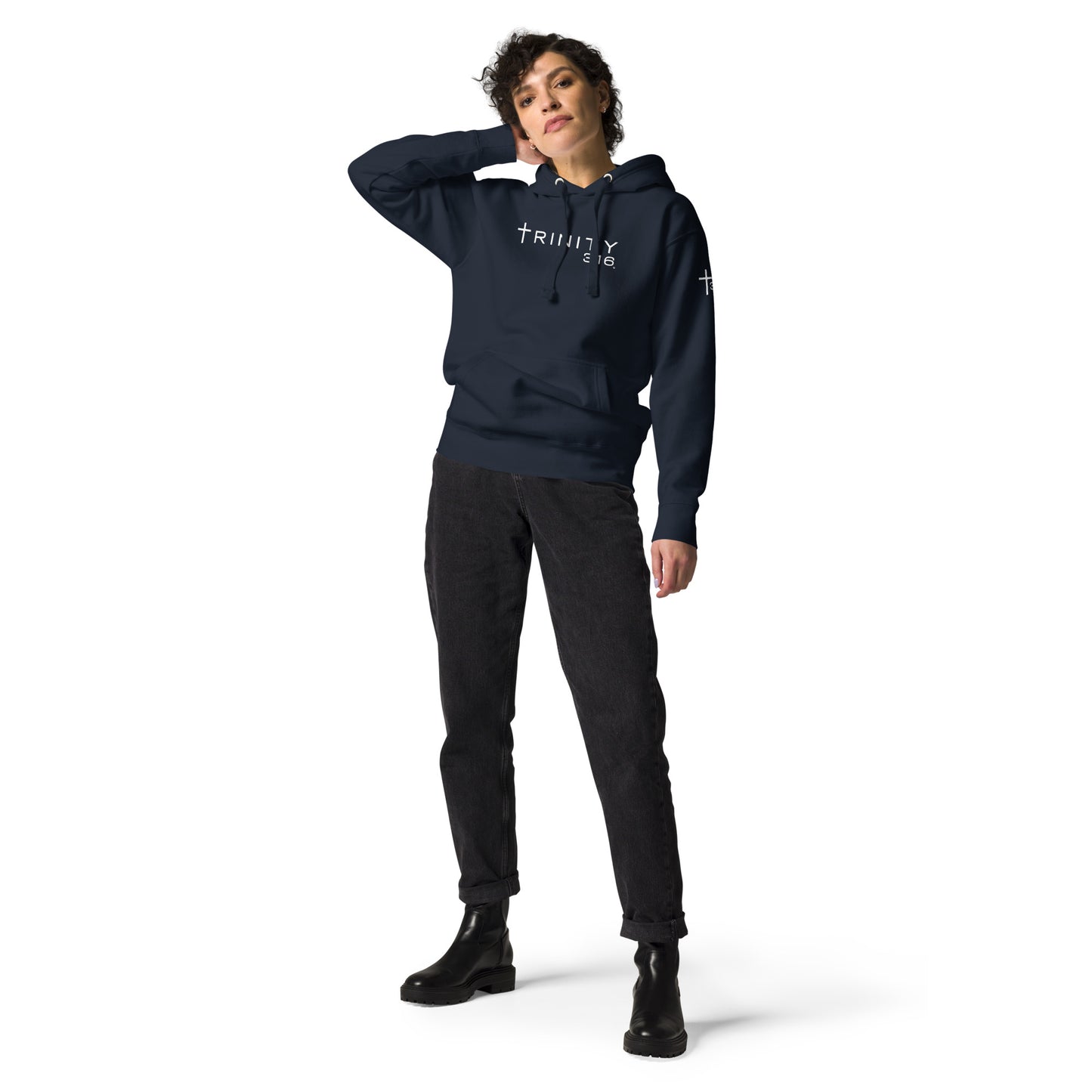 A woman in a navy blazer unisex premium hoodie displaying the message Trinity 316 prominently on the front.