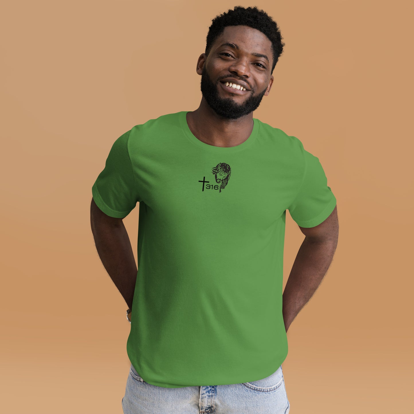 A black man models a green unisex staple t-shirt with a logo, showcasing the leaf front design.