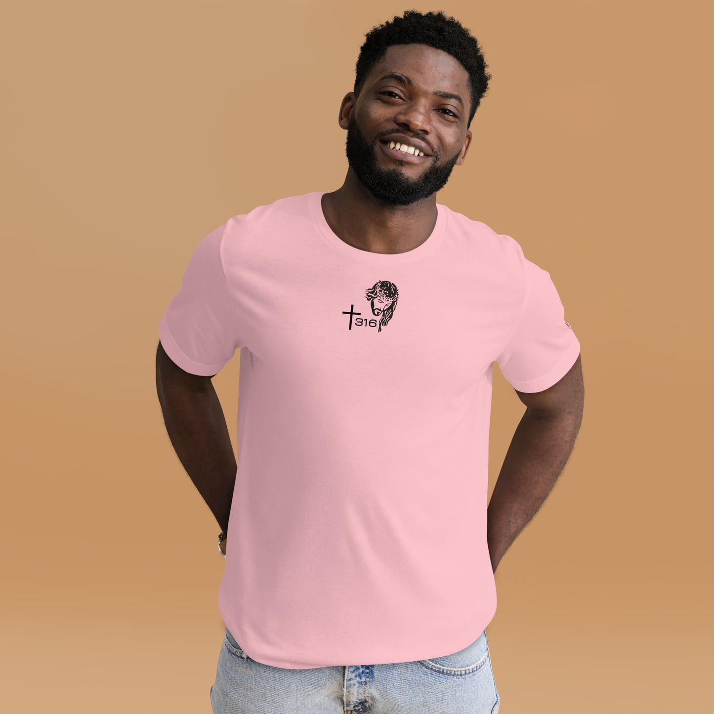 A man in a pink t-shirt featuring a black logo, standing confidently against a neutral background.