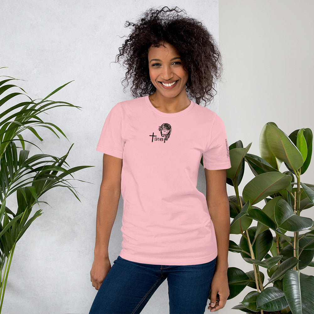 A woman in a pink t-shirt featuring a striking black and white design, showcasing a stylish and casual look.