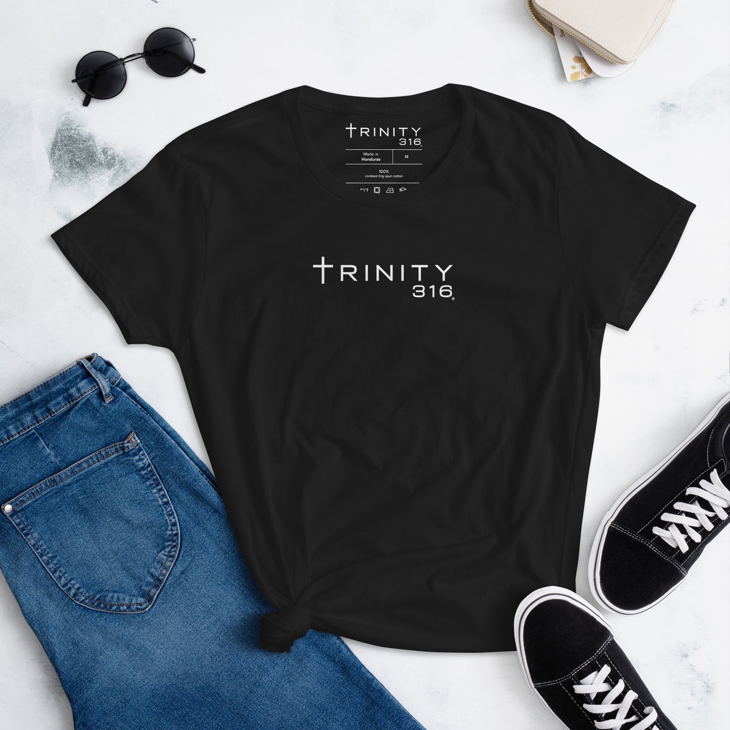 Front view of a black women's fashion fit t-shirt showcasing a trinity graphic, ideal for stylish outfits.