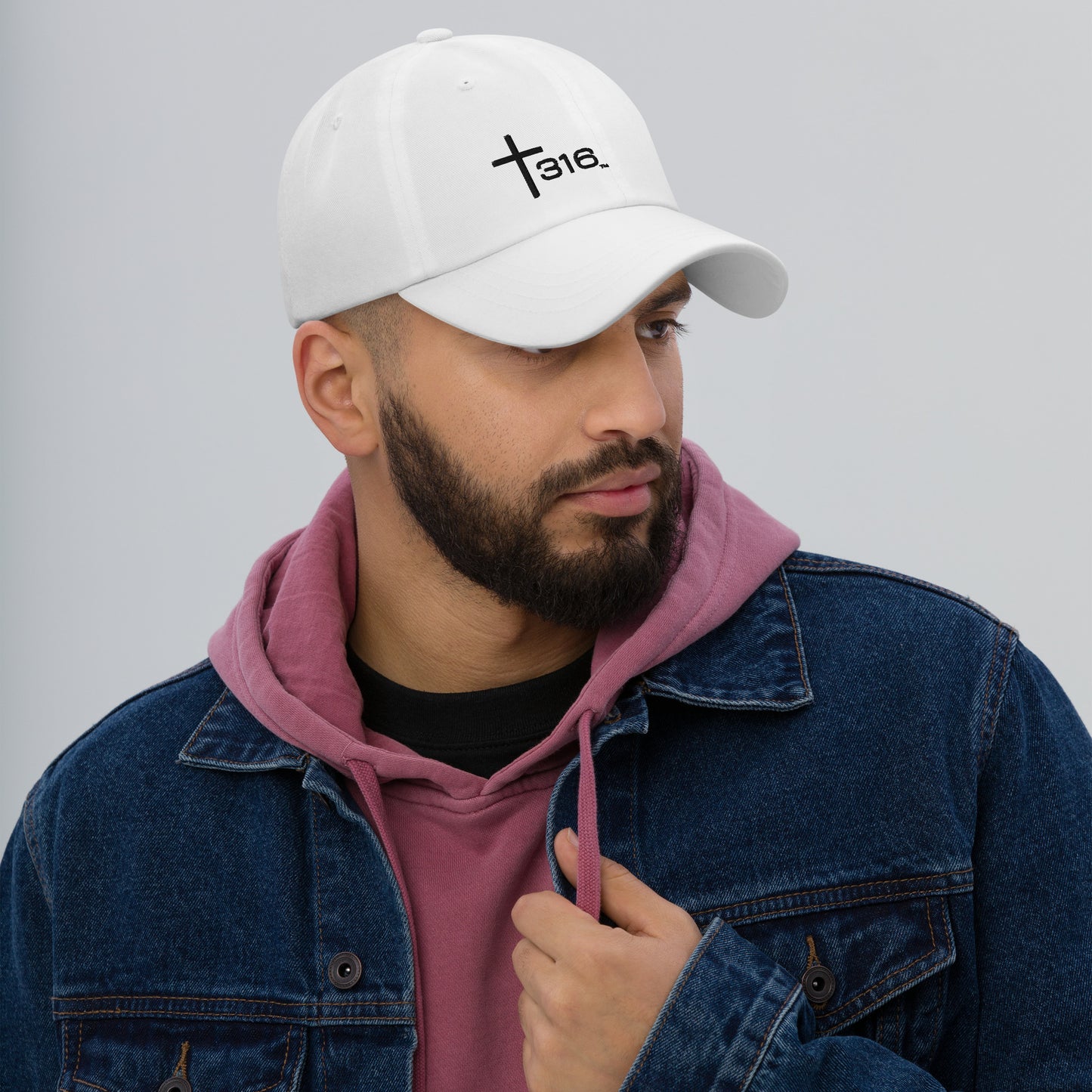 A man wearing a white classic dad hat with "faith" written on the front, showcasing a casual yet meaningful style.