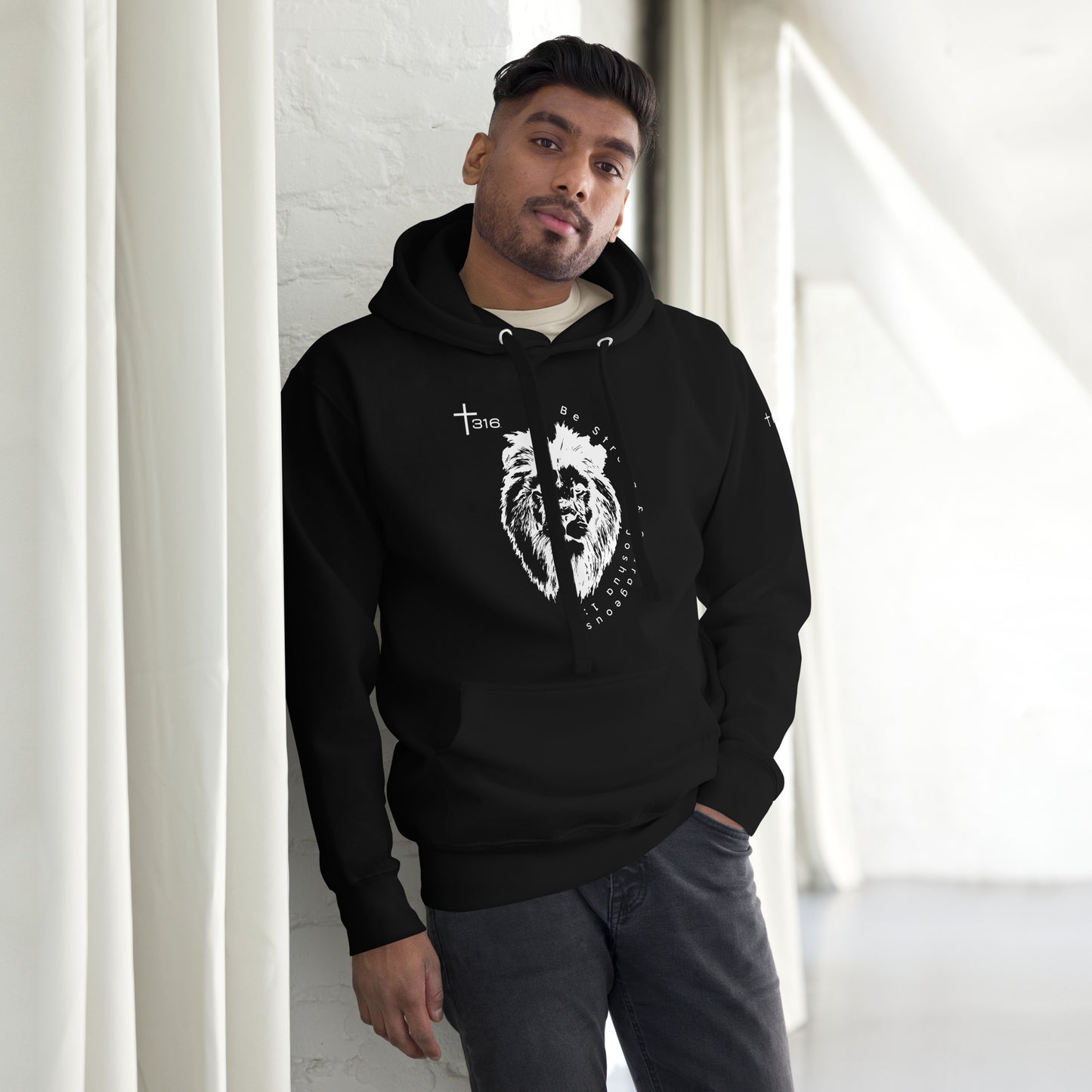 A man in a black hoodie featuring a heart design, showcasing the unisex-premium-hoodie-black-front style.