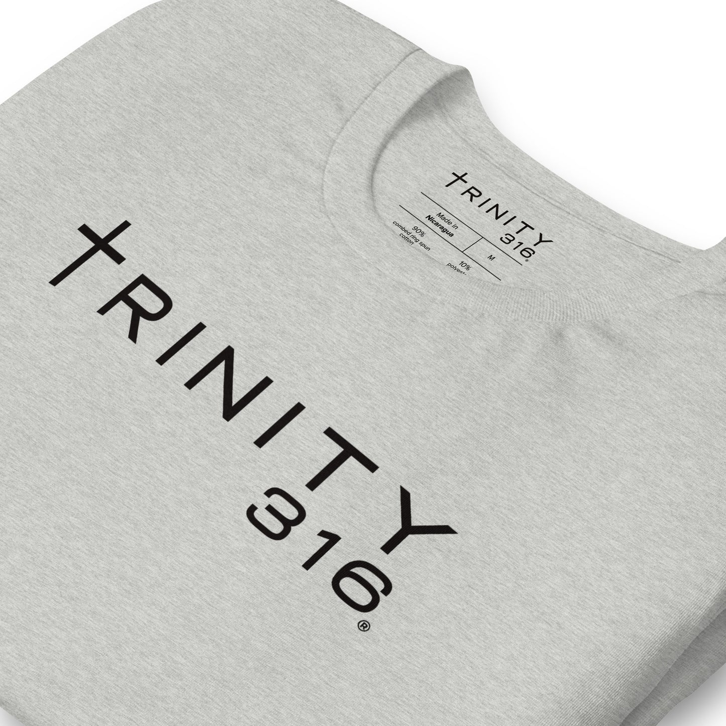 A close-up of a grey sweatshirt featuring the word trinity 316, showcasing its unisex-staple-t-shirt-athletic-heather-zoomed-in design.