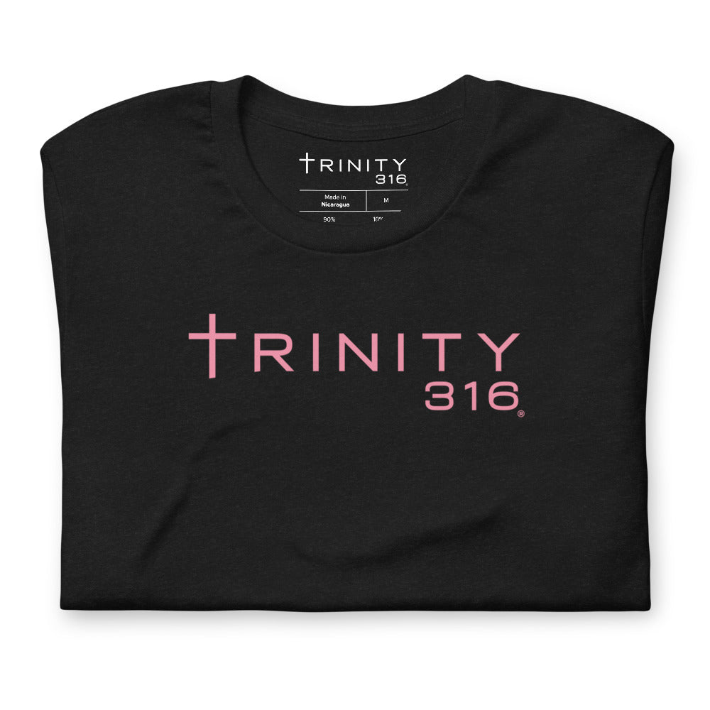 Front view of a black staple t-shirt with "trinity" printed in pink, highlighting a contemporary fashion statement.