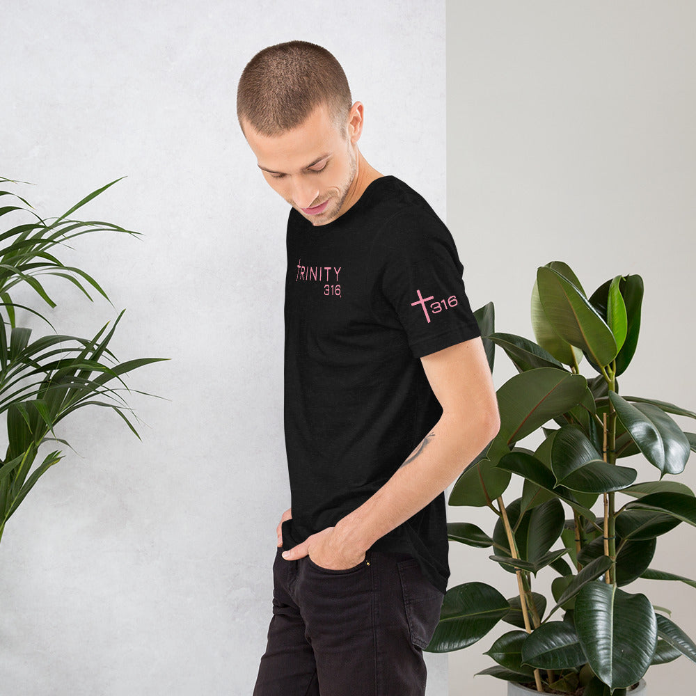 A man in a black t-shirt with pink letters, showcasing a unisex staple t-shirt in black heather from the left side.
