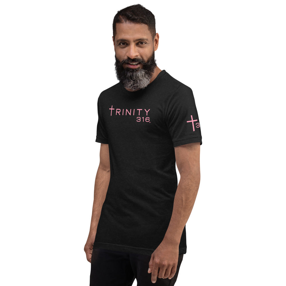 A bearded man in a black shirt featuring trinity 316 in pink, showcasing a unisex staple t-shirt design.