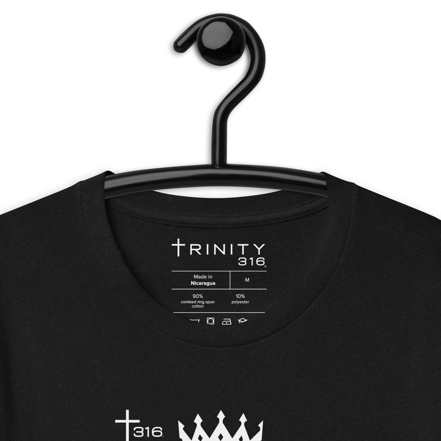 Close-up of a black t-shirt showcasing the text "Trinity" and "Crown" in a stylish font.