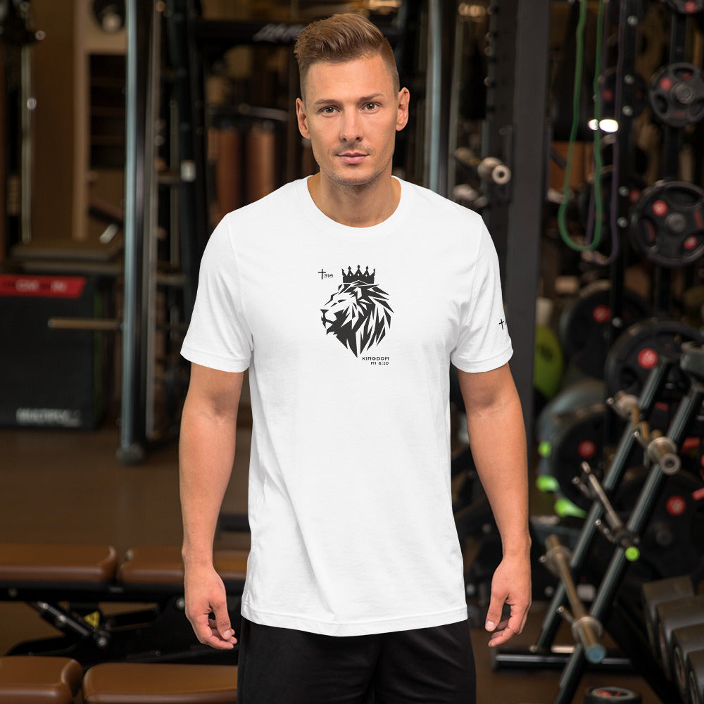A man poses in front of a gym, dressed in a white t-shirt adorned with a lion graphic.